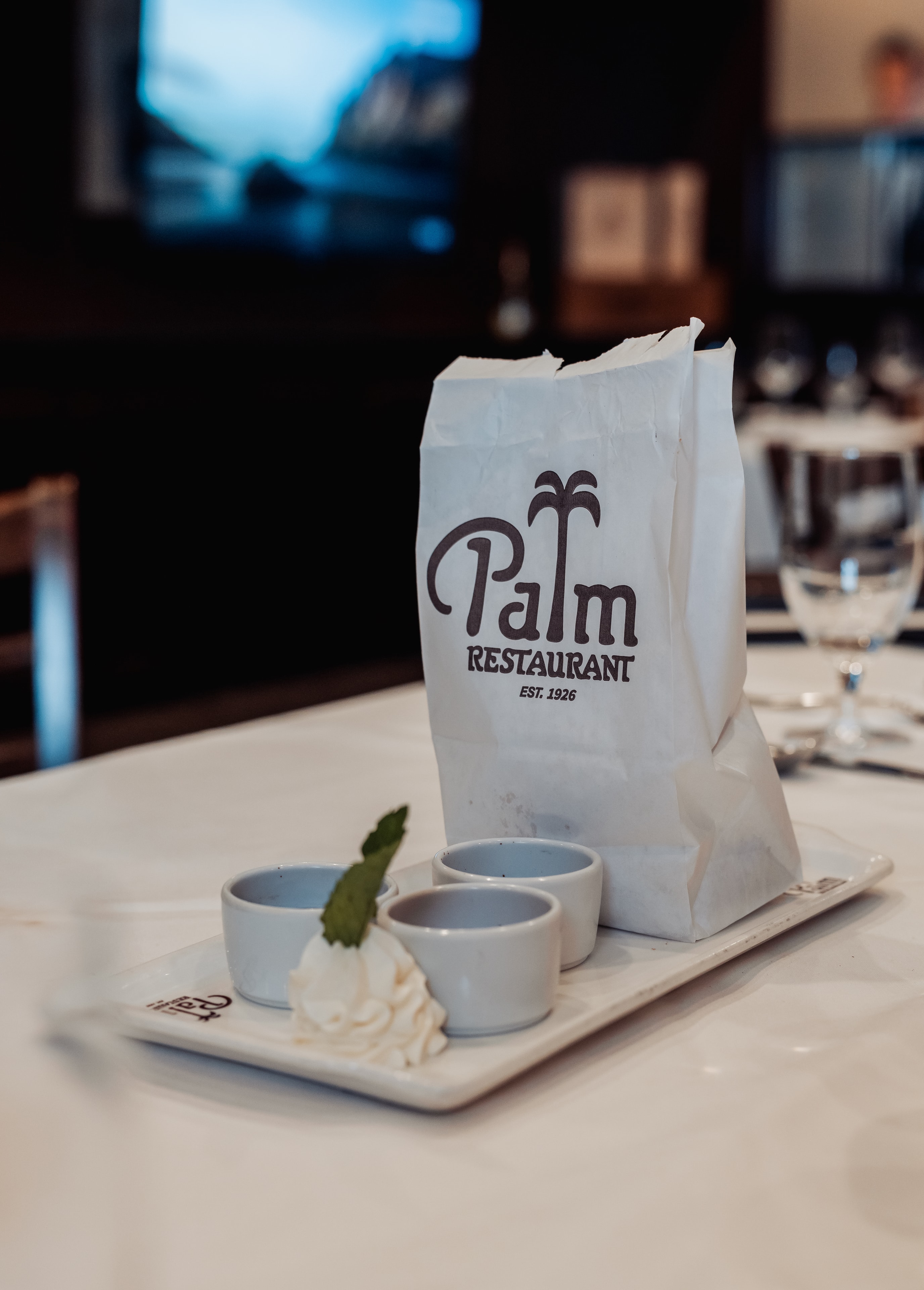 Palm Restaurant branded bag and table setting established 1926
